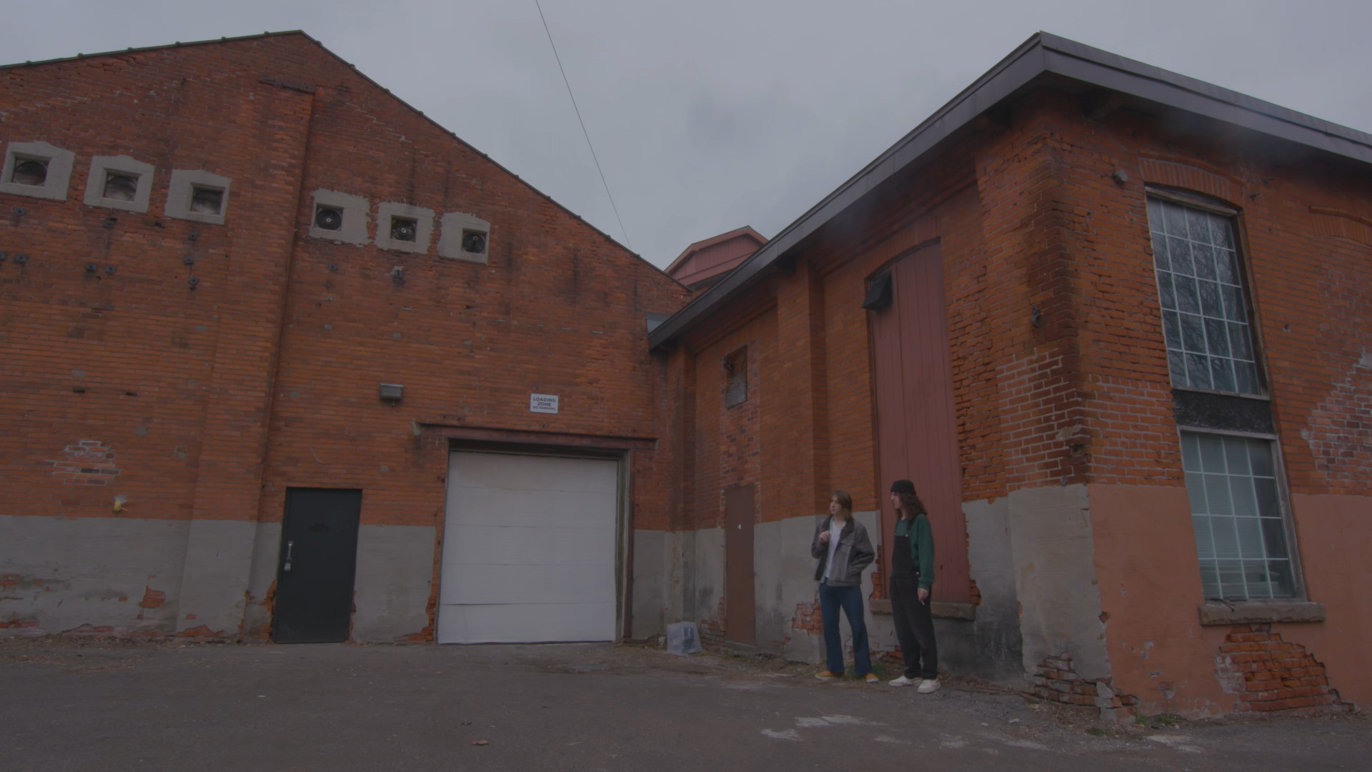 Tyler and Darius standing outside a warehouse.